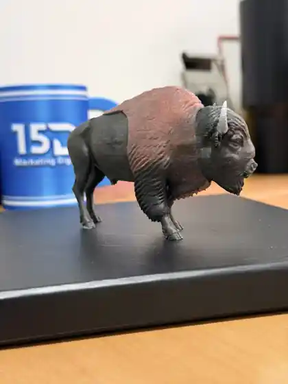 Bisão decorativo marrom e grafite impresso em 3D sobre uma base